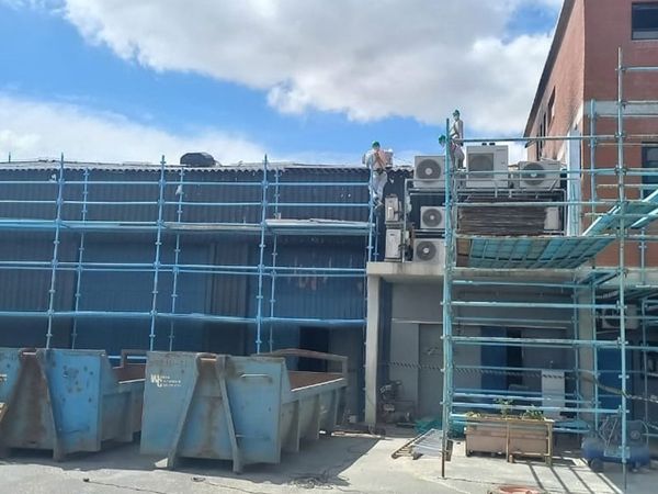 Asbestos roof sheets being removed