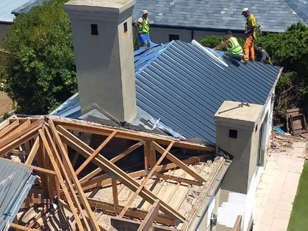 New timber trusses and roof sheeting being installed