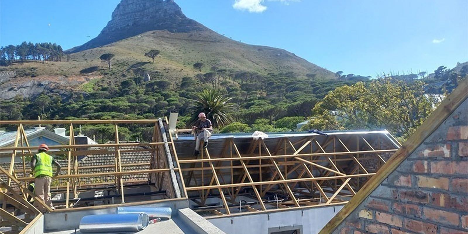 Timber roof trusses being erected beneath Lion's Head, Cape Town
