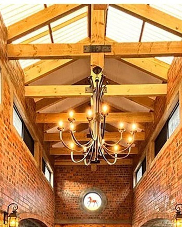 Exposed timber trusses inside a completed Rome Roofing project