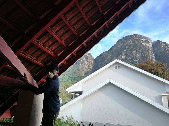Roof maintenance inspection beneath a tiled roof